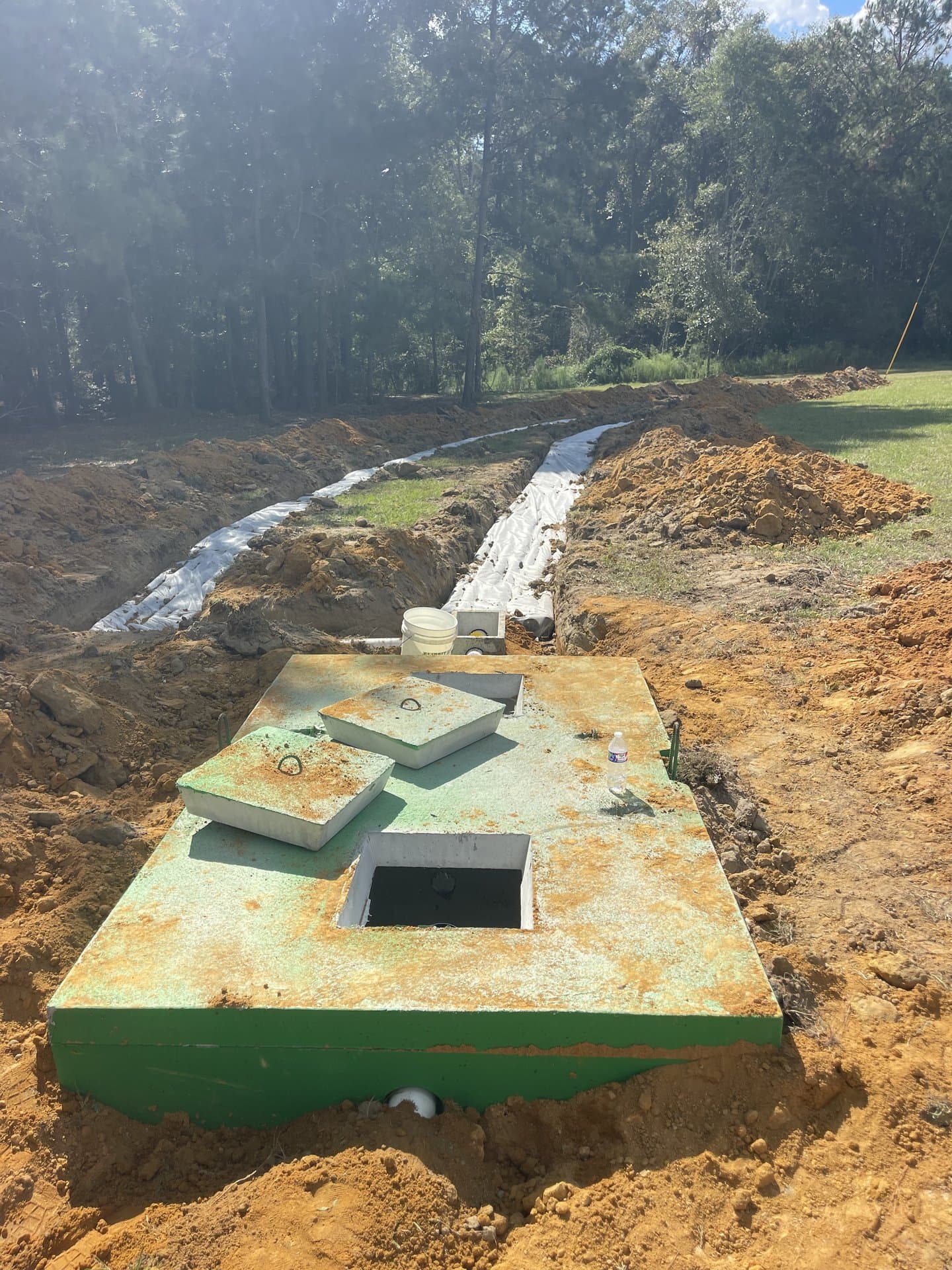Concrete septic tank with access lids exposed